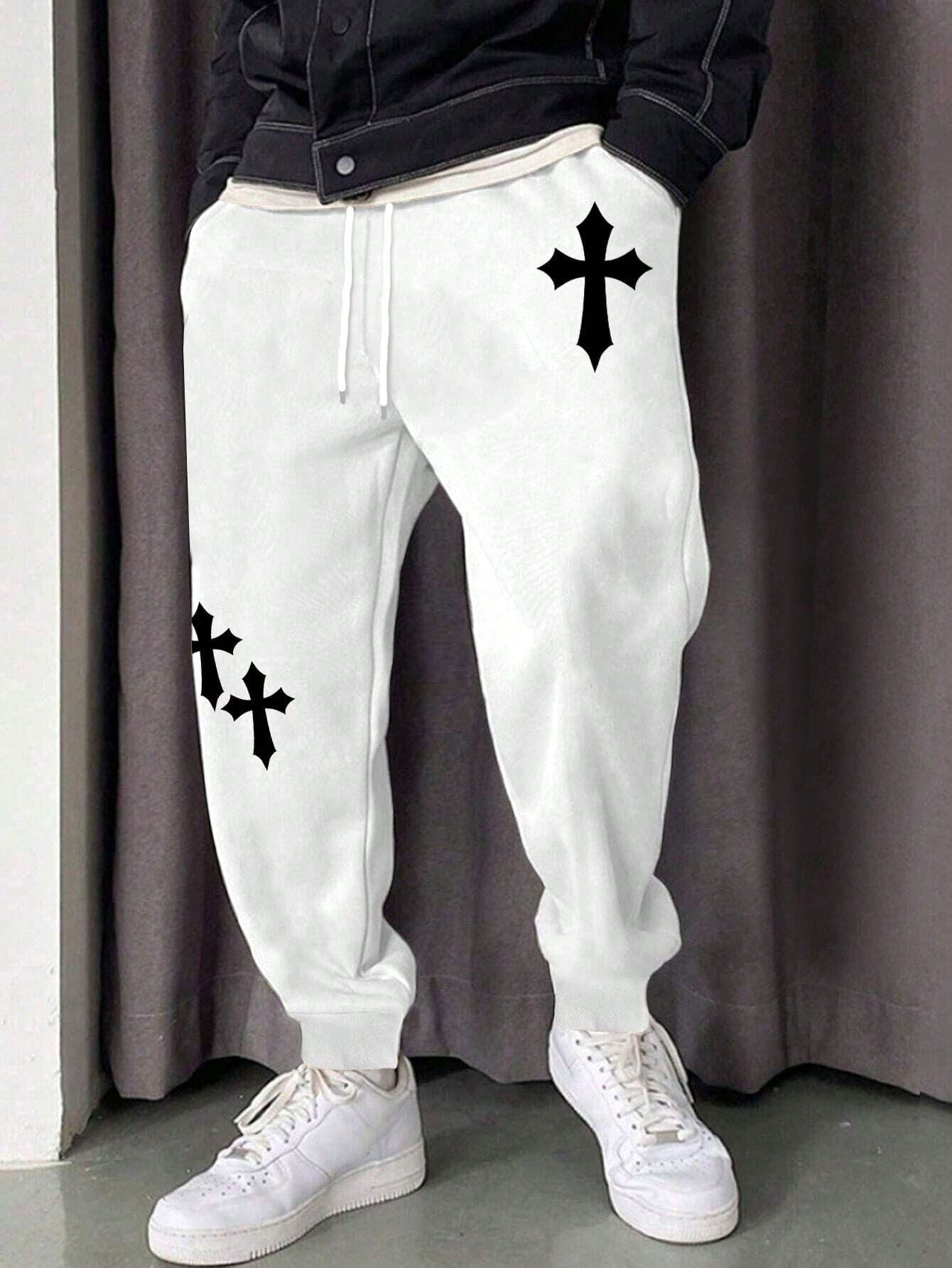 Manfinity EMRG Men'S Street Style Black Asymmetric Cross Print Tapered Sweatpants with White Track Pants.