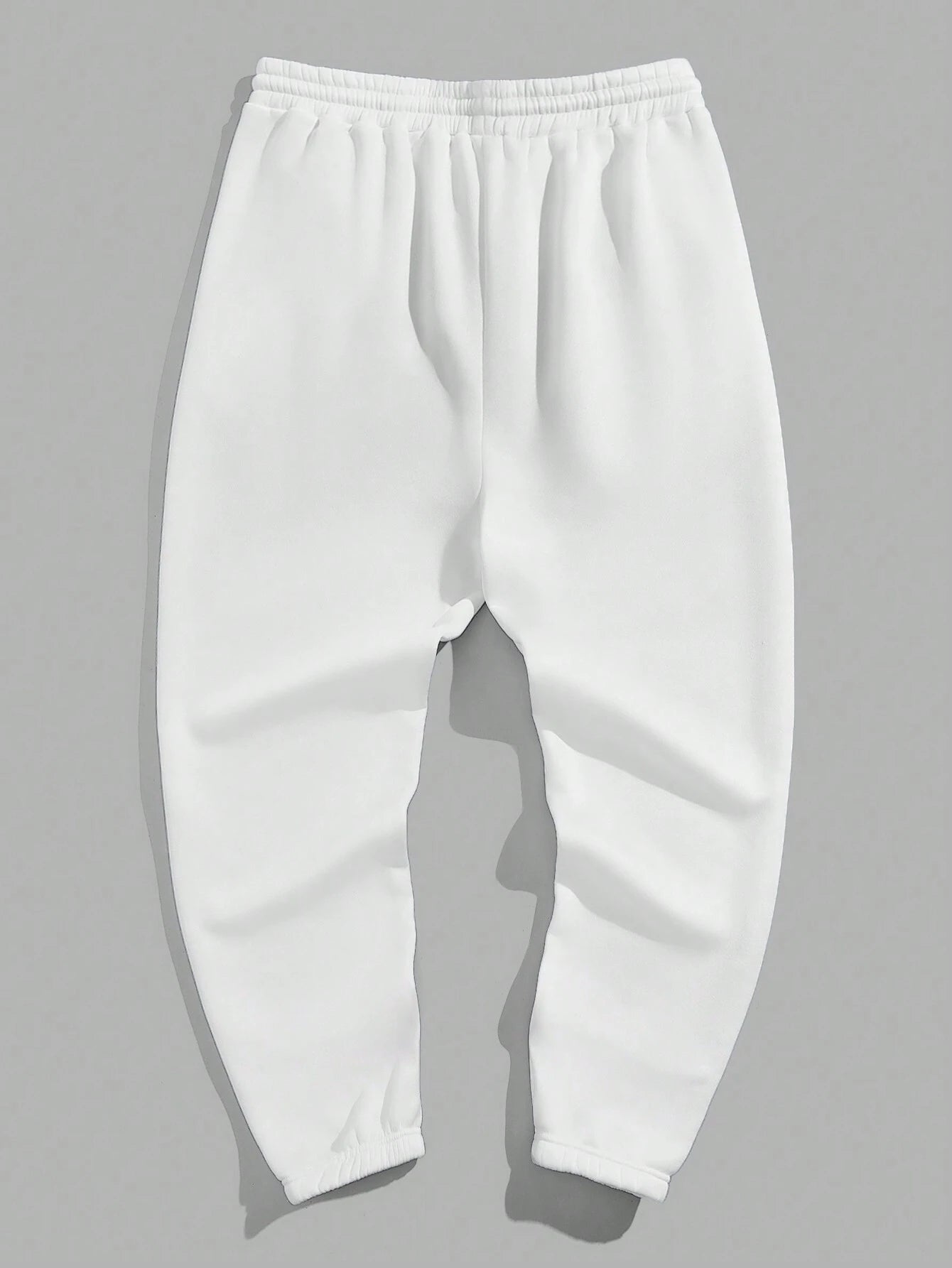 Manfinity EMRG Men'S Street Style Black Asymmetric Cross Print Tapered Sweatpants with White Track Pants.